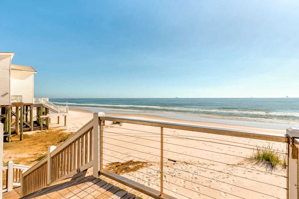 Step outside to sweeping Gulf views and soft white sand just beyond the deck. True Dauphin Island beachfront living with direct access to the shore.