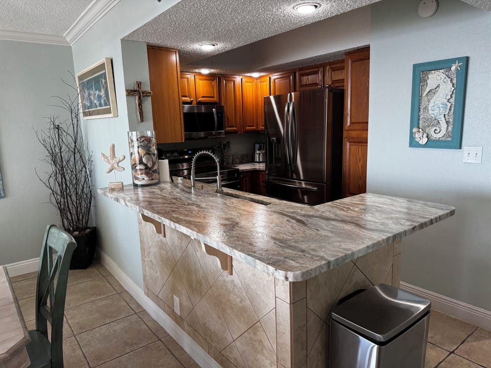 Kitchen with new Samsung stainless steel appliances.