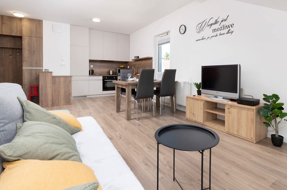 A compact living space featuring a gray sofa with colorful cushions, perfect for relaxing.