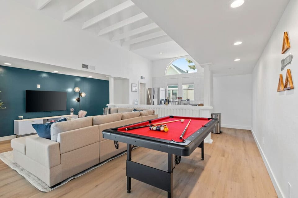 Relax in the cozy living room upstairs with comfortable furniture and chairs. Enjoy entertainment with the nice TV and engage in friendly competition with the pool table. Experience a great stay filled with comfort, fun, and memorable moments.