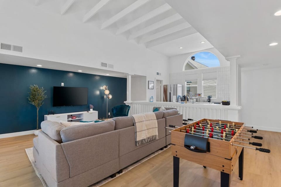 Relax in the cozy living room with comfortable furniture and chairs. Enjoy entertainment with the TV and engage in friendly competition with the foosball table. Experience a great stay filled with comfort and fun, and memorable moments.