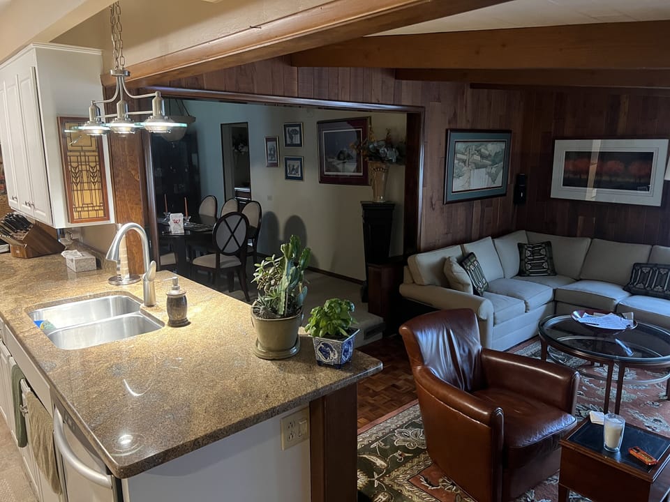 A look through kitchen into FR to DR