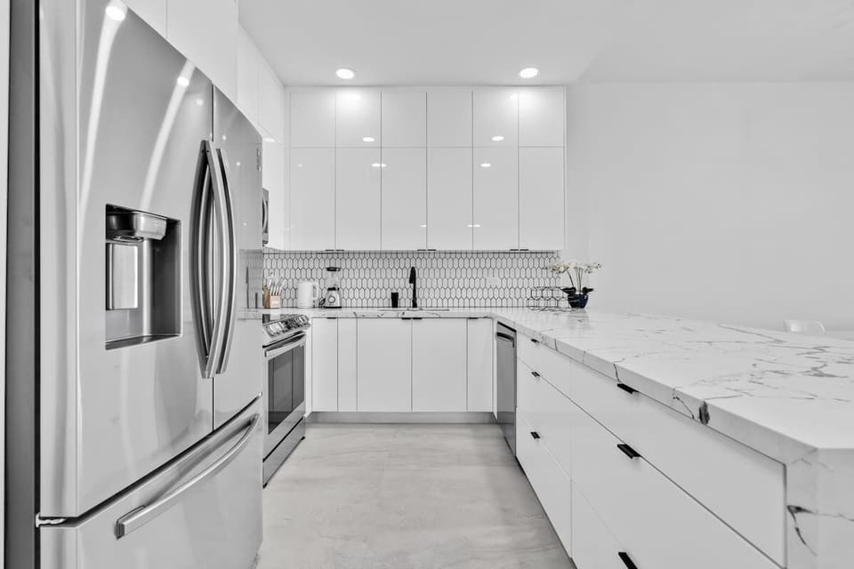 Contemporary kitchen with stainless steel appliances and geometric tile flair—perfect for extended stays.