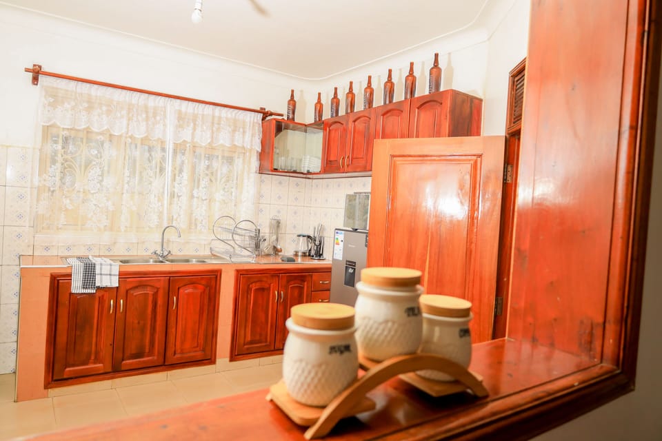 Kitchen with washing machine, fridge, cooker and microwave