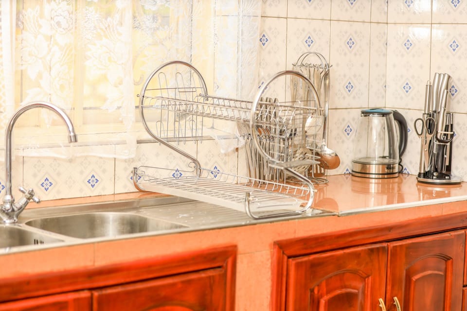 Kitchen with washing machine, fridge, cooker and microwave