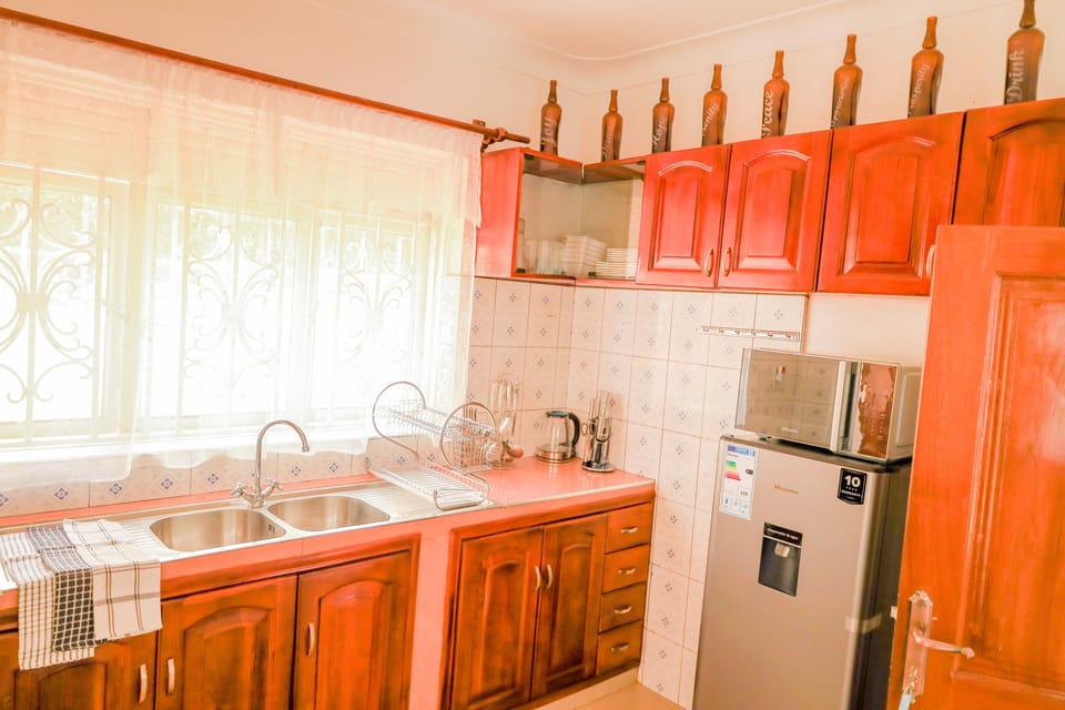 Kitchen with washing machine, fridge, cooker and microwave