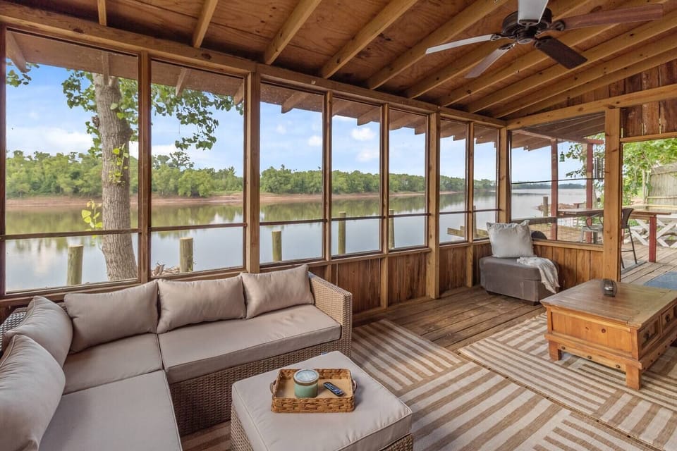 The screened porch has 2 seating areas and a TV is mounted on the wall! Perfect for watching movies & football games!