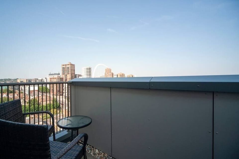 Located just off the living room, this private balcony on the 12th floor provides an enchanting view of Wembley Stadium. Equipped with two chairs, two stools, and a table, it offers a cosy and inviting space to relax and enjoy the scenery.