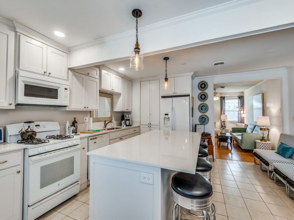 020 MCM House Kitchen to Living; French double door fridge and amenities in view