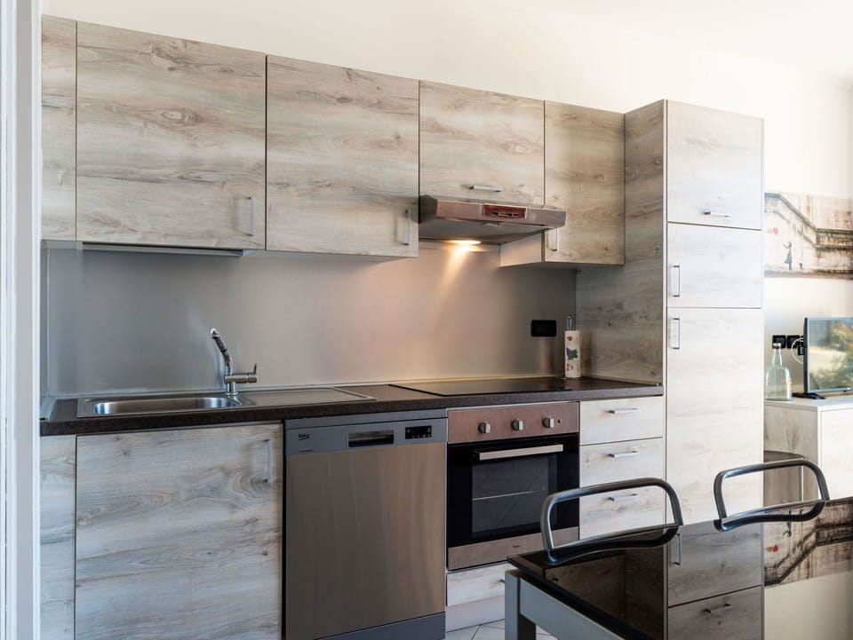 Cabinetry, Kitchen Appliance, Countertop, Kitchen, Furniture, Wood, Flooring, Interior Design, Major Appliance, Home Appliance
