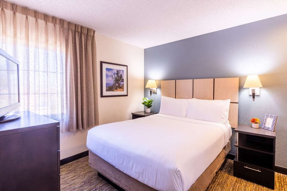 Unwind in crisp linens and soft light after exploring.