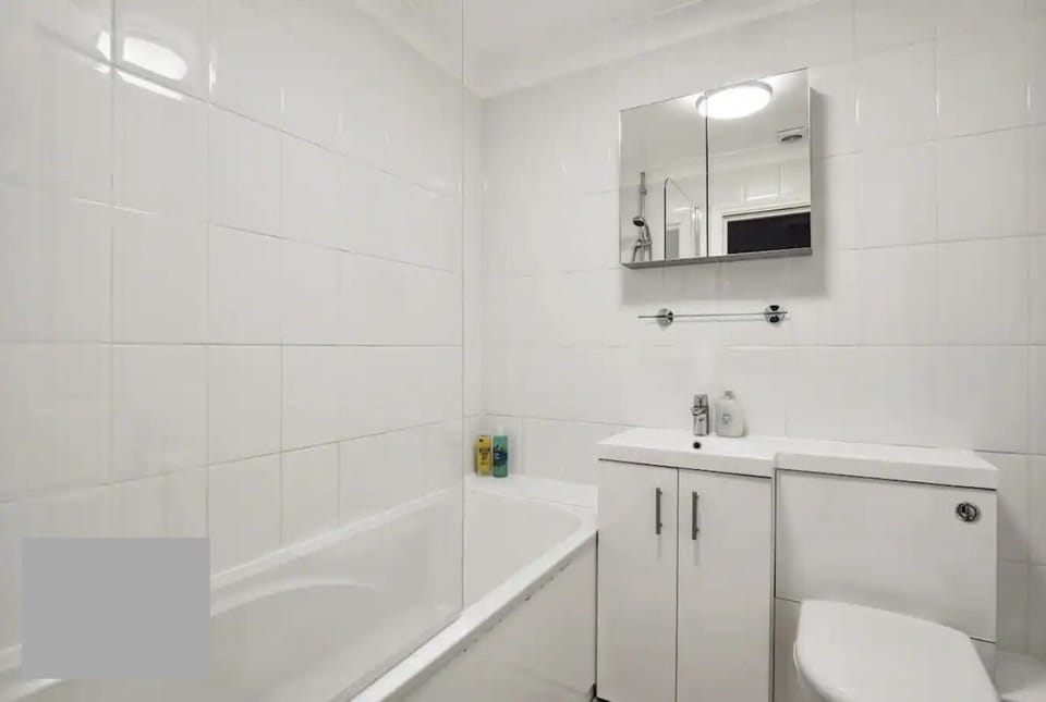 Step into serenity in our pristine bathroom, boasting clean, white walls that create a calming oasis for your stay.