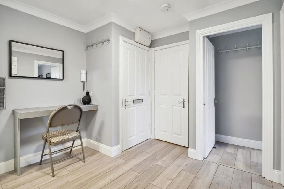 Elevate your workday in our chic workstation corner, framed by a modern mix of gray and white walls for a sophisticated ambiance.