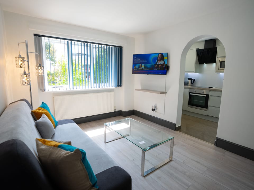 Living area with way to the kitchen, allowing for easy movement between the two areas. 