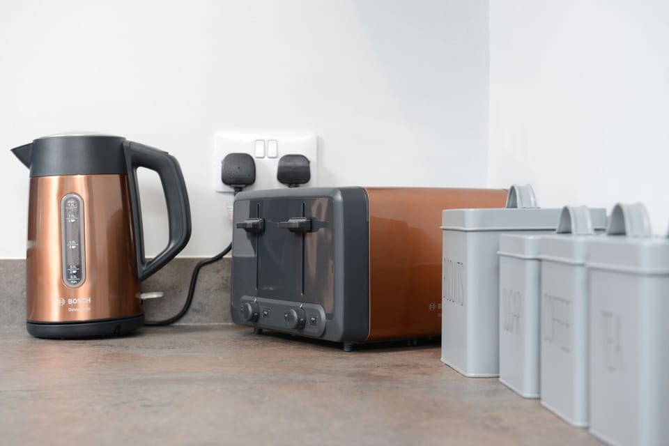 Meet your kitchen's stylish sidekicks: our sleek appliances and chic canisters, perched atop the countertop to streamline your culinary adventures in modern flair.