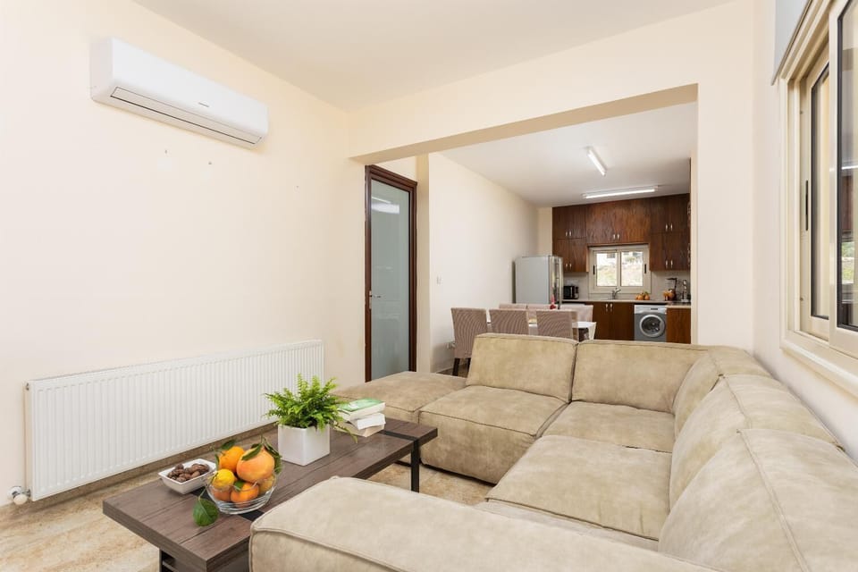 Open-plan living room with sofa, dining area, kitchen, A/C, WiFi internet, satellite TV, and terrace access