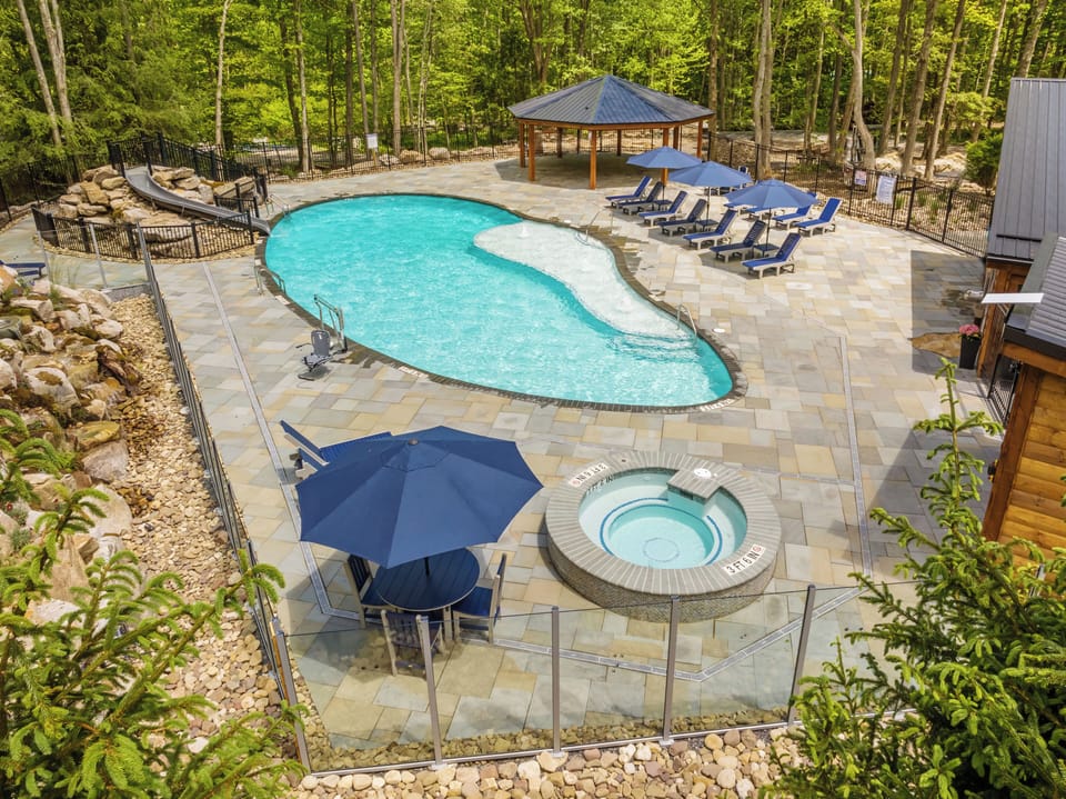 Community 70'x35' saltwater pool with a slide, hot tub, ADA lift, sports courts, and fitness center.