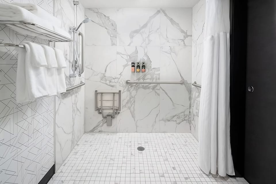 Refresh under a spa-like rainfall shower with sleek tile.