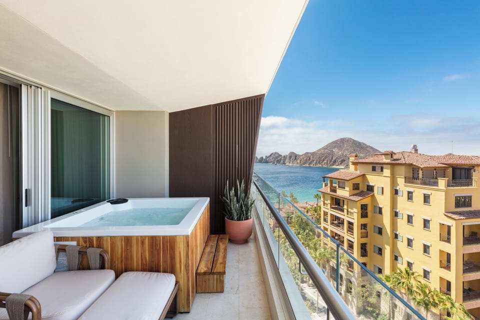 Stretch out on cushioned loungers beside your private hot tub.