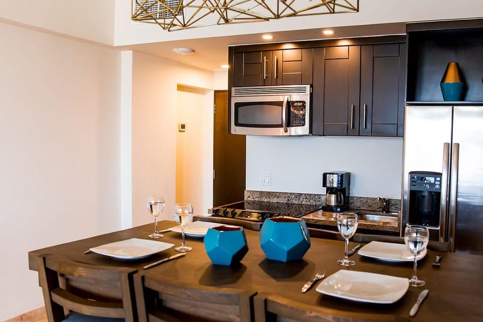 Enjoy a relaxed dinner setting under warm, modern lighting.