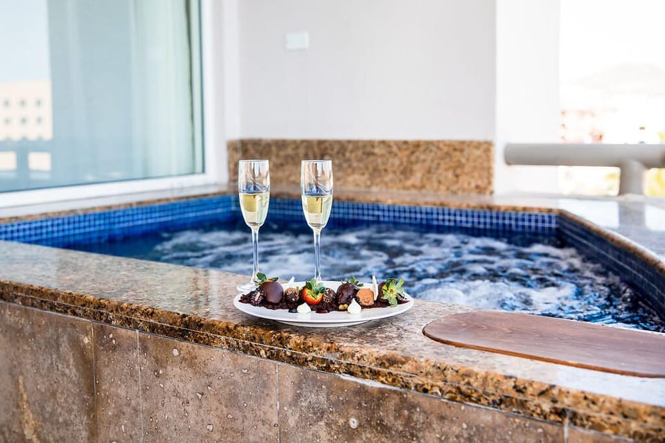 Soak in warm bubbling waters with treats and sunset sips.