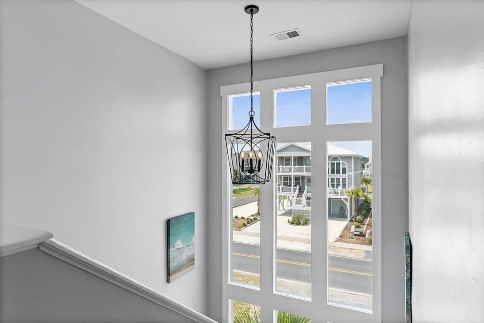 Stairway to Paradise: Bright, airy space with stunning views and a stylish chandelier!