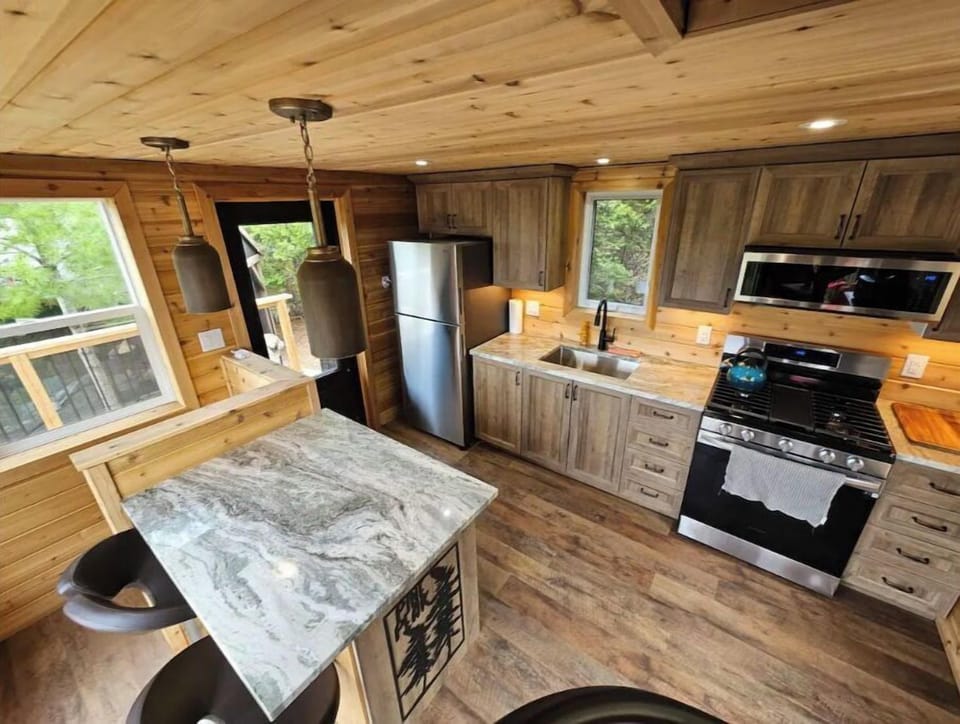 Fully outfitted kitchen with propane stove and full size fridge on main floor