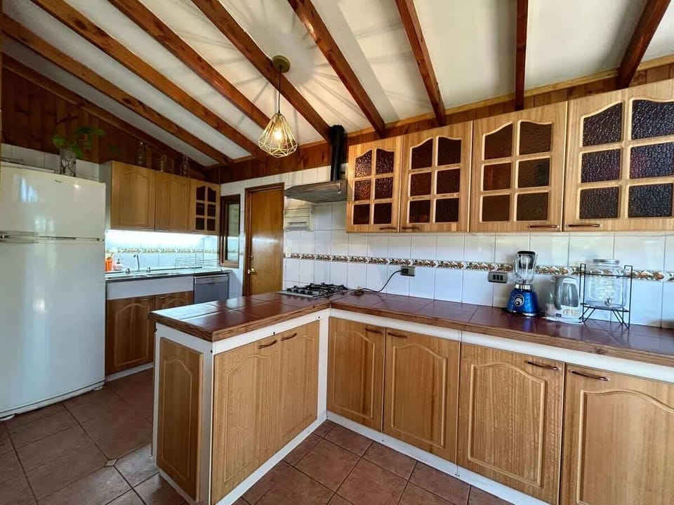 Rustic kitchen w/ wood cabinetry & plenty of room to cook together