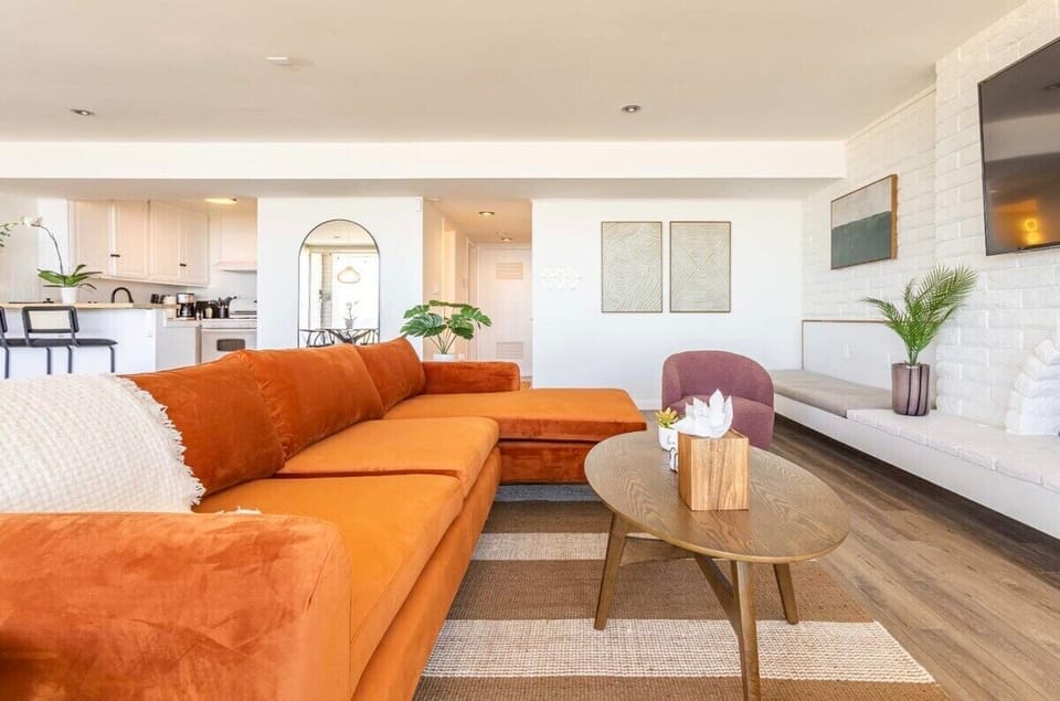 Bright, stylish, and steps from the sand—this living room is perfect for relaxing with ocean breezes flowing in.