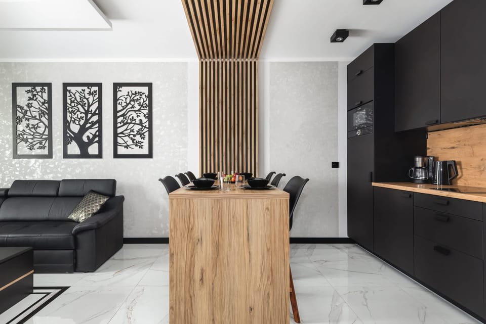 Dining area with table, tableware and kitchenette.