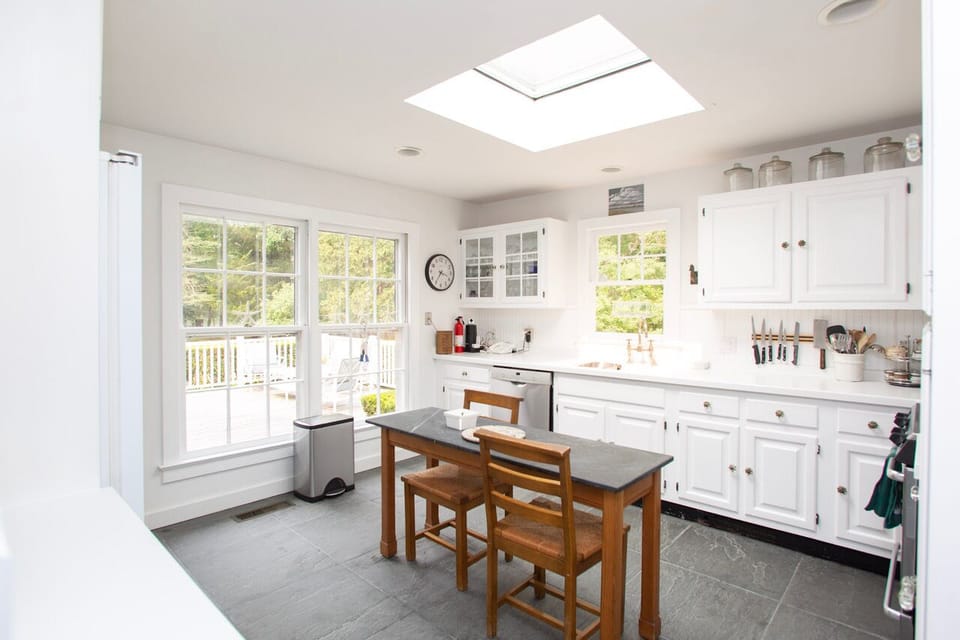 Bright kitchen w/ access to the back porch & entrance to elegant dining & foyer