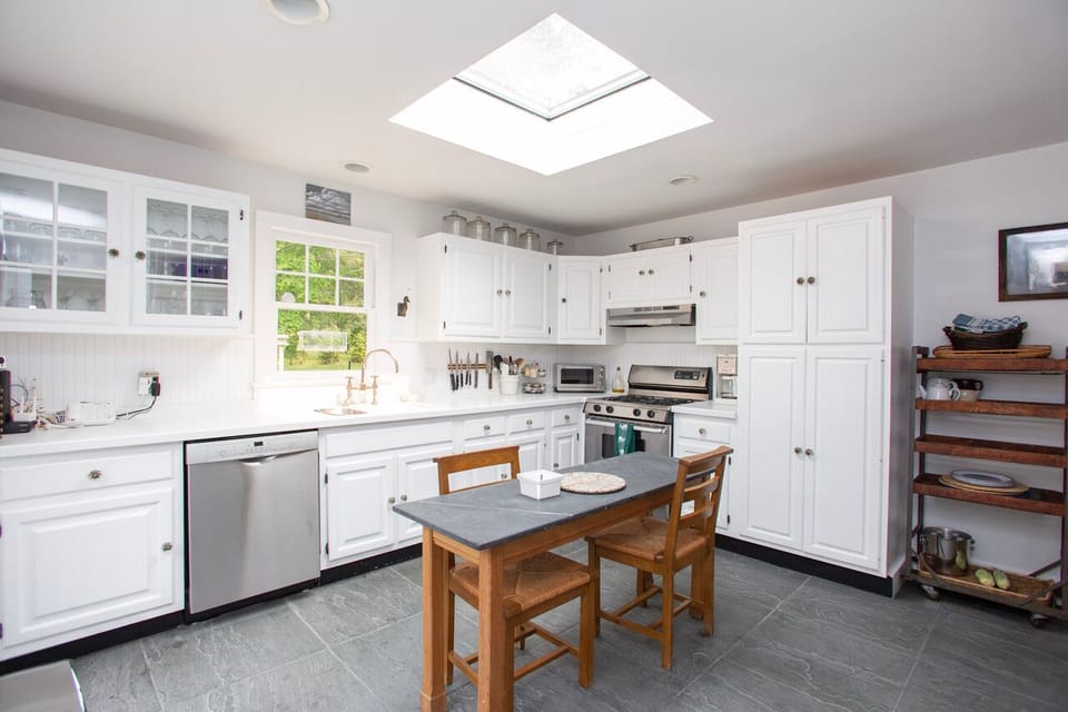 Bright kitchen w/ access to the back porch & entrance to elegant dining & foyer