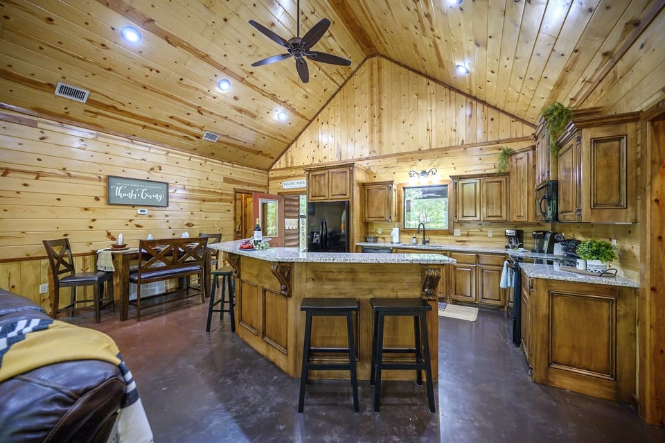 Large kitchen with island and seating at bar and table.