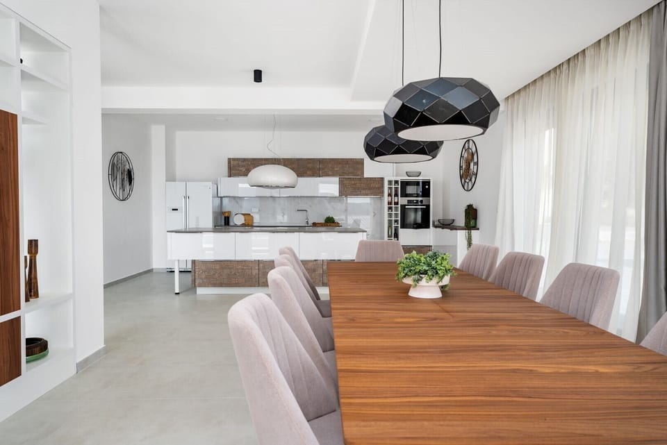 Fully equipped kitchen with an island and luxuriously decorated dining room with a magical view of the crystal blue sea