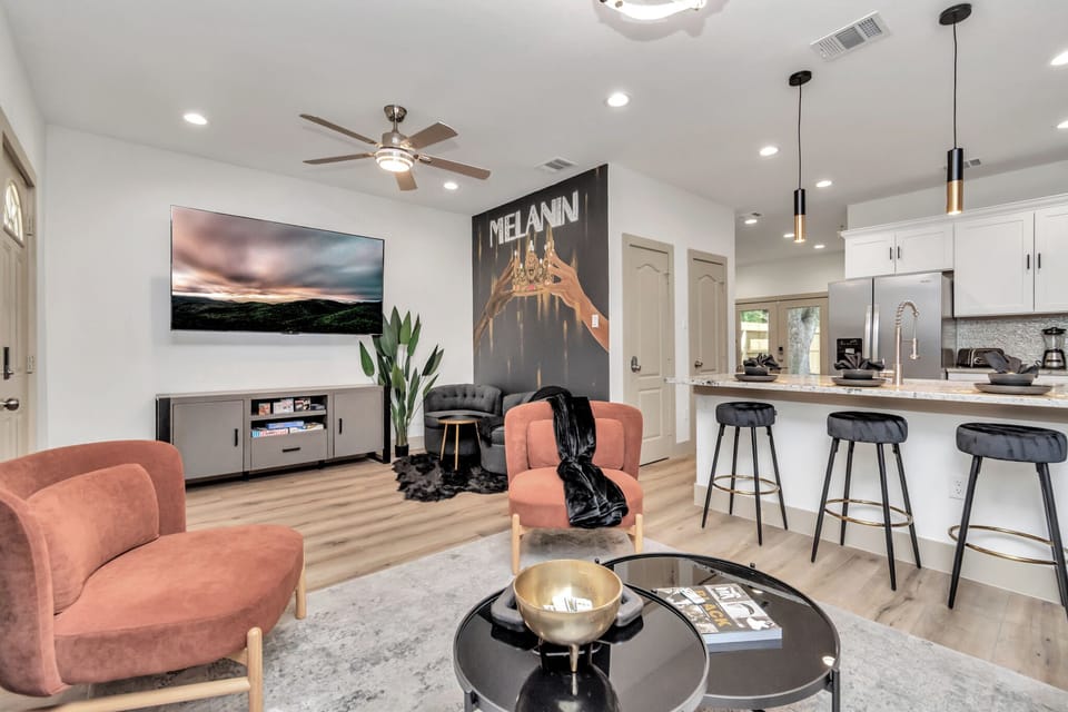 Living Room with 75-inch TV, board games, LED lights, and a perfect photo op at the Melanin wall