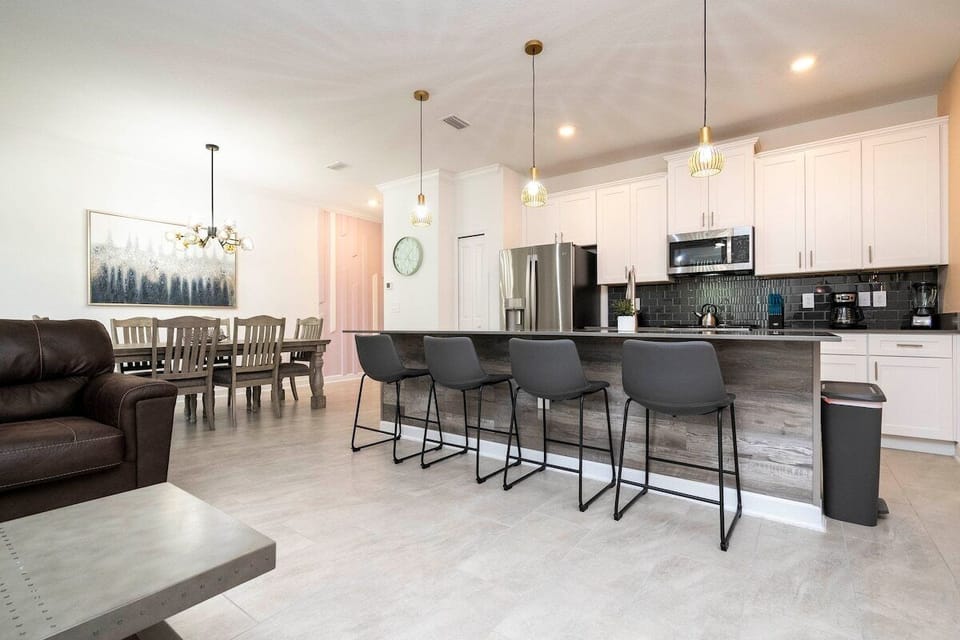 The fully equipped kitchen features modern appliances, sleek cabinetry, and all essential cookware and utensils, making it perfect for preparing meals with ease.