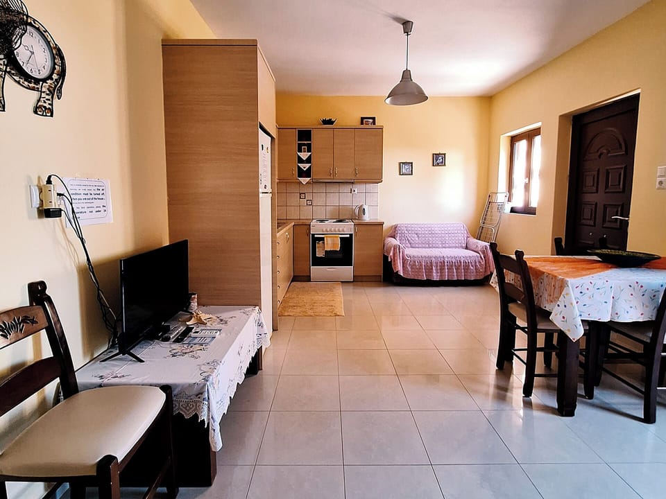 Open-plan living and dining area with air conditioning & TV