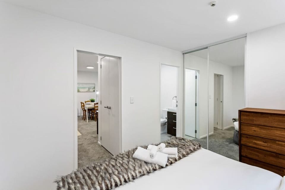 View into the ensuite bathroom and storage cupboards.