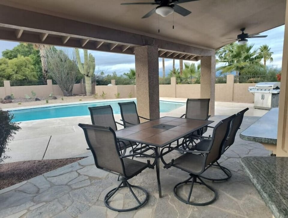 Patio table with 6 swivel chairs.  Two ceiling fans with lights on dimmers.