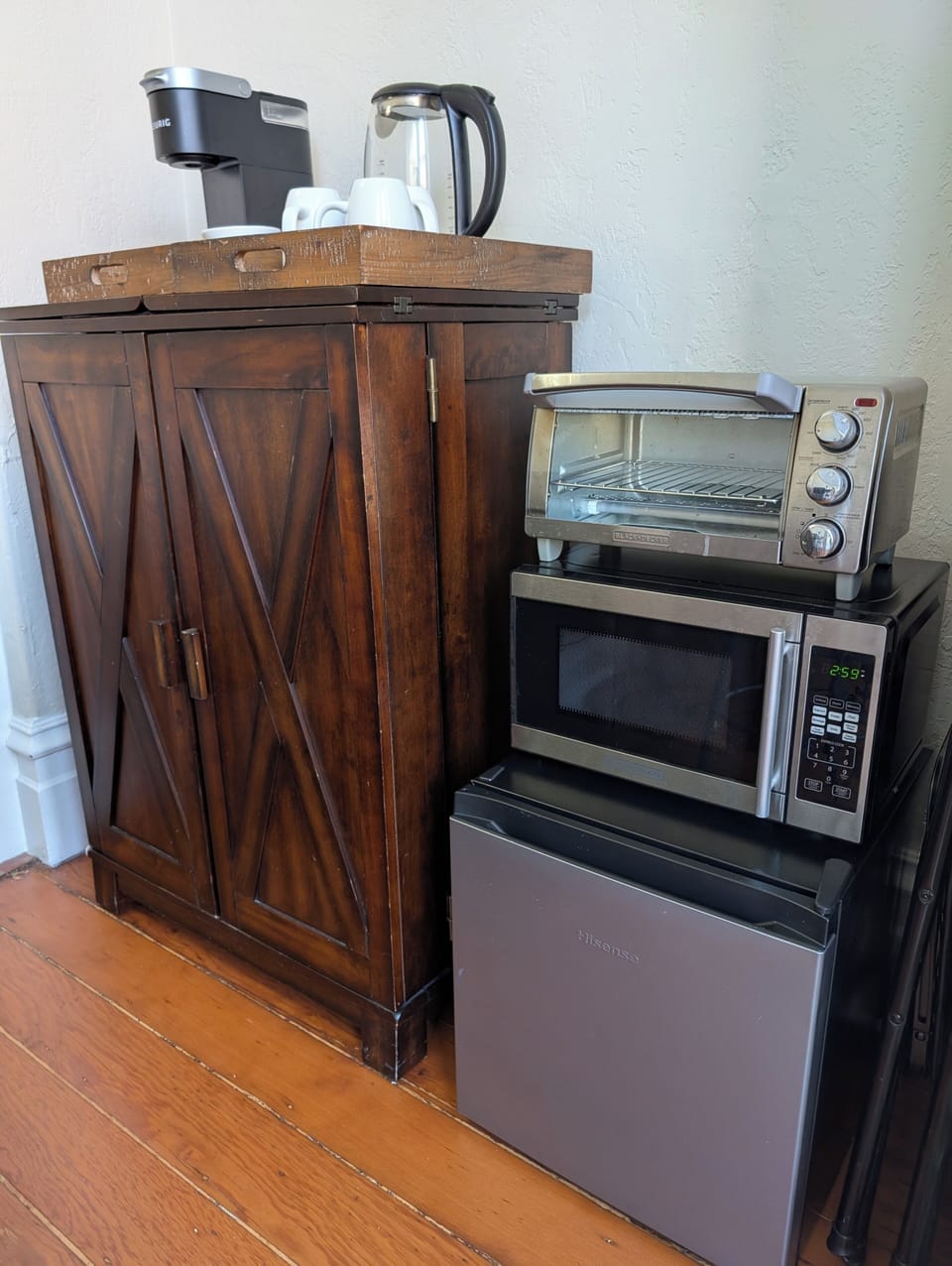 Kitchenette with coffee, tea, dishes, utensils, microwave, fridge, toaster oven.