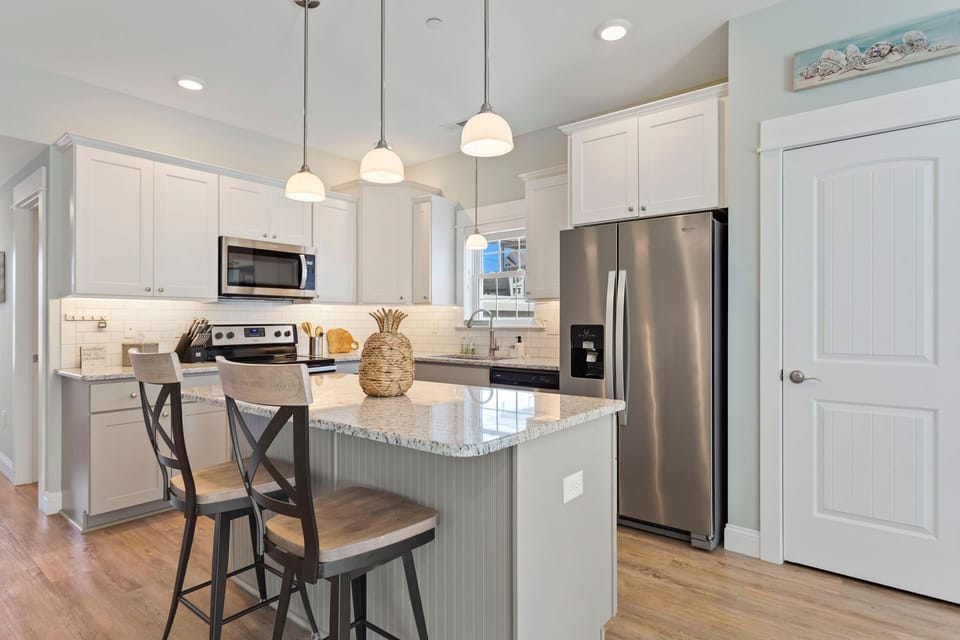 The modern Kitchen with granite countertops and stainless steel Whirpool Gold appliances is perfect for preparing an incredible meal.