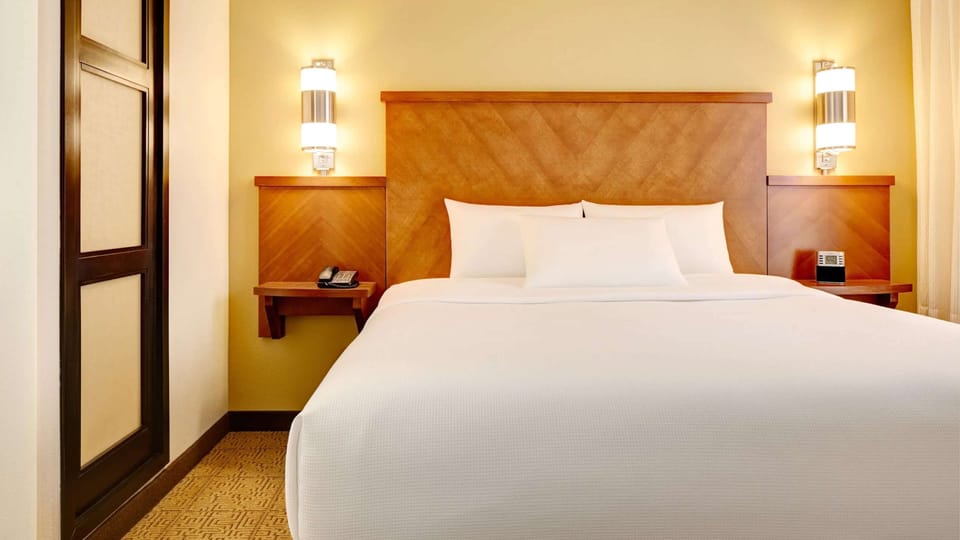 Relax beside warm lighting and an inviting, plush bed.