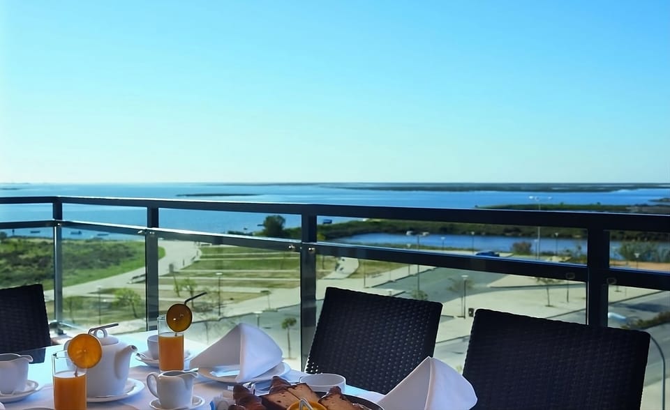 Savor sunrise coffee on the balcony overlooking calm waters.