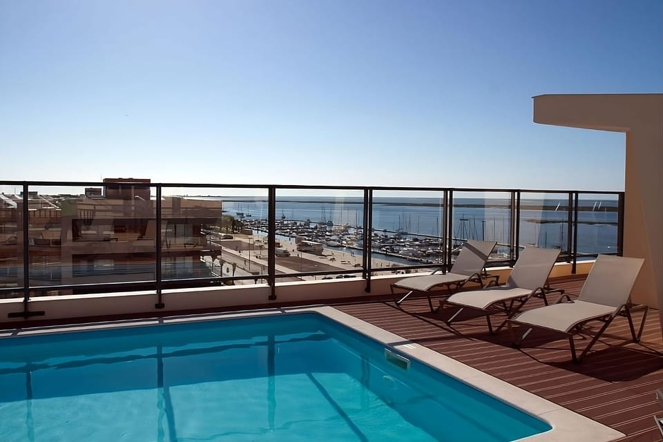 Soak up sunshine by the rooftop pool overlooking the marina.