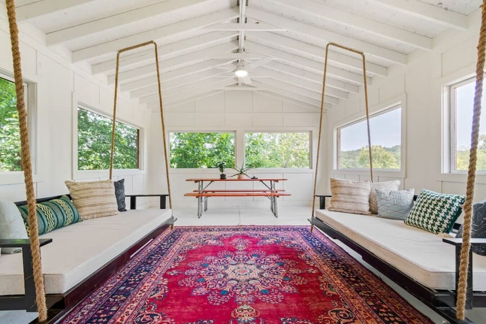 Bright and colorful porch space perfect for card games, eating at the picnic table, or relaxing with your morning coffee.