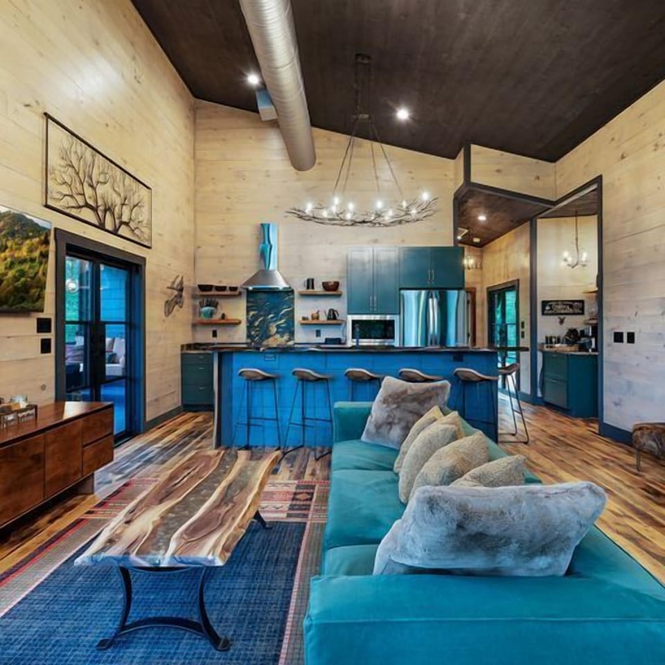 The open living kitchen in the treehouse seamlessly blends culinary artistry with a warm and inviting space for gathering and relaxing.