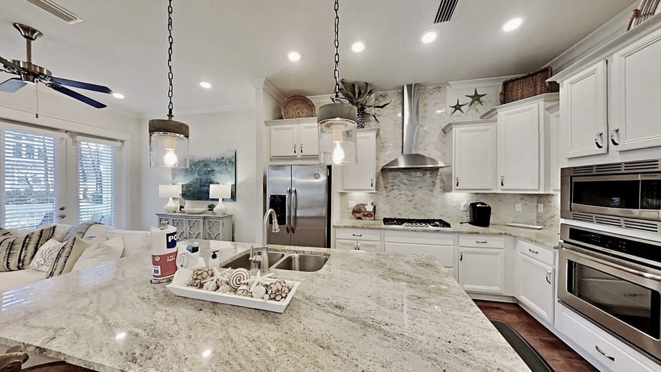 Full kitchen with stainless appliances, gas stove and large island.