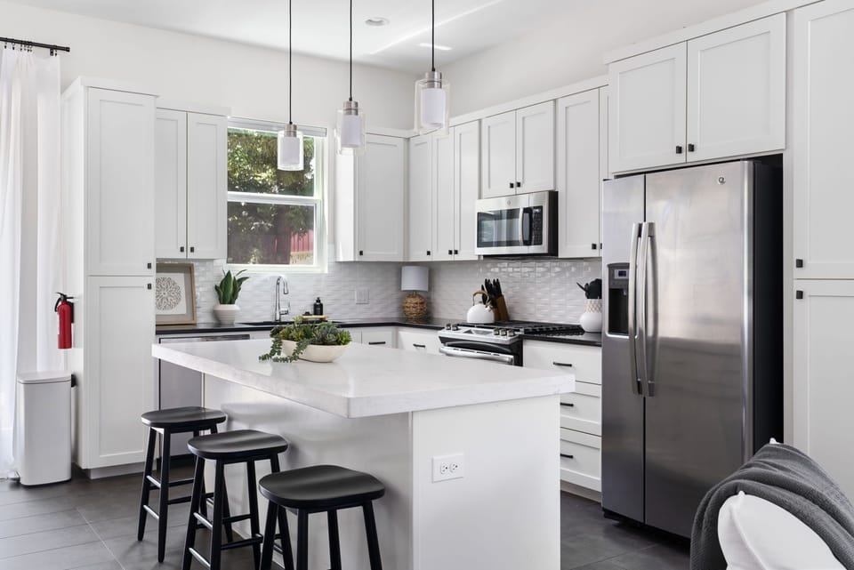(Main floor) kitchen w/ stainless steel appliances and breakfast bar