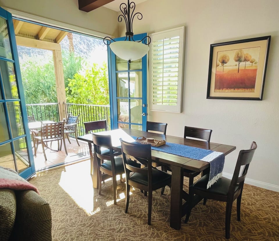 Dining area with seating for six. French doors open to the main balcony.