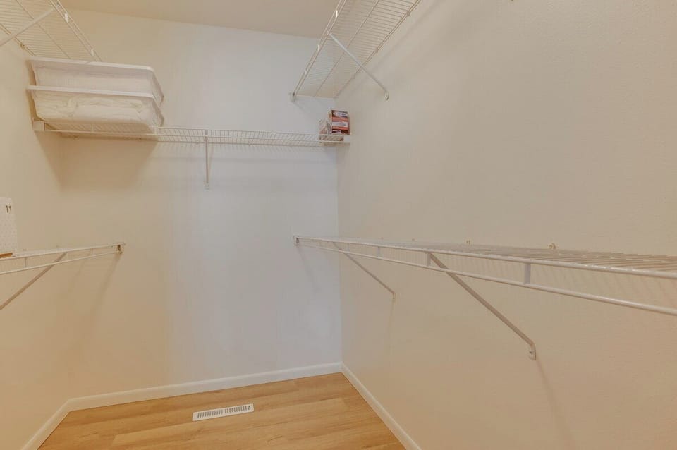 Explore the Master Bedroom's generous walk-in closet, complete with essential amenities such as ironing board and iron, stand-alone highchair, and a pack and play for the little ones.